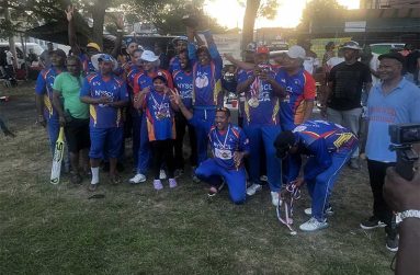 The victorious NYSCL Legends players pose with their winnings. NYSCL President Eric Ferrier is at extreme right.