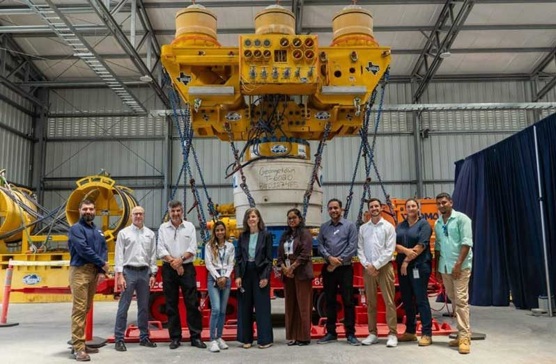 Representatives from government, industry, and emergency-response organisations stand in front of OSRL’s Guyana Capping Stack at the new Subsea Response facility at VEHSI. (OSRL photo)