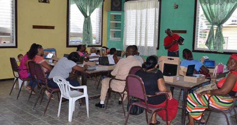Some residents of Linden participating in training on how to use their devices during the OLPF distribution exercise in Region 10