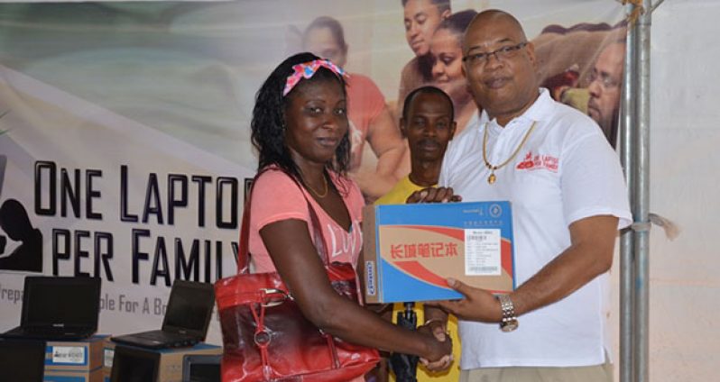 This Linden resident receives her laptop from Minister in the Ministry of Finance, Juan Edghill