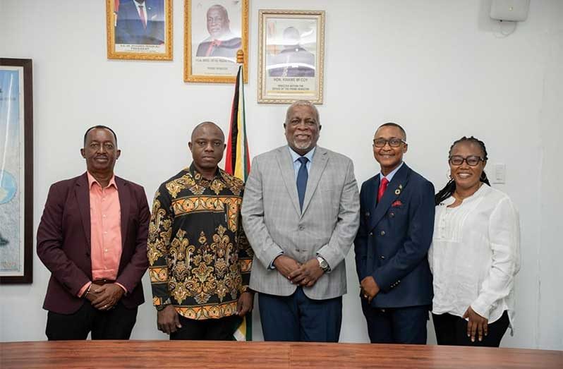 Prime Minister, Brigadier (Ret’d) Mark Phillips, flanked by representatives of the Revealed Word Christian Center