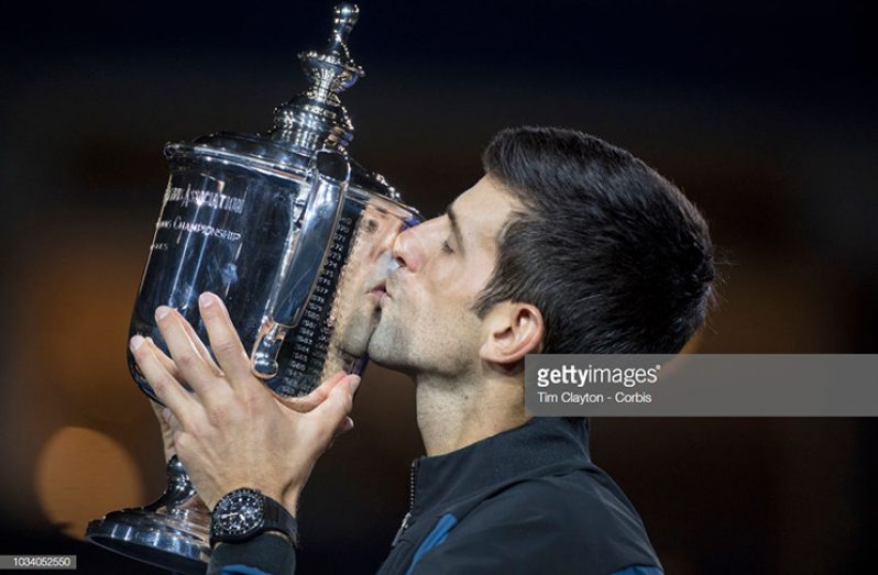 Novak Djokovic of Serbia celebrates with the trophy after his victory against Juan Martin Del Potro of Argentina, in the Men's Singles Final at the 2018 US Open Tennis Tournament at the USTA Billie Jean King National Tennis Centre on September 9th, 2018 in Flushing, Queens, New York City. (Novak Djokovic of Serbia celebrates with the trophy