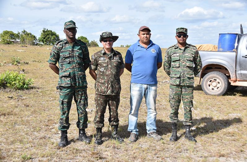 Officers of the Guyana and Brazil armies and a civilian on the ground Sunday