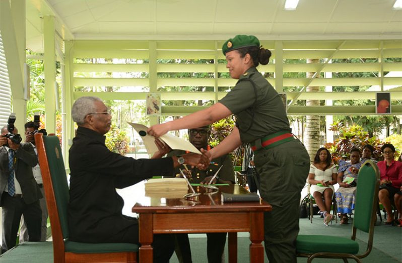 President David Granger presents Lt Van Lange with her instrument of commission