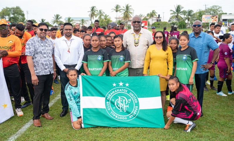 Prime Minister Mark Phillips (centre) and other government officials with one of the football teams contesting the Games.