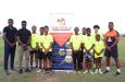 Officials from InSync Therapeutics and Vurlon Mills Football Academy, along with some of the players in the programme
