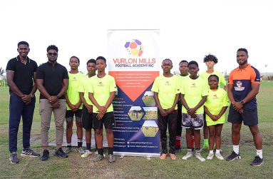 Officials from InSync Therapeutics and Vurlon Mills Football Academy, along with some of the players in the programme