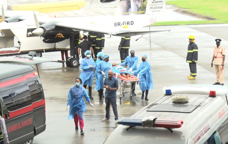 Medical personnel wheel one of the survivors to a waiting ambulance (DPI photo)
