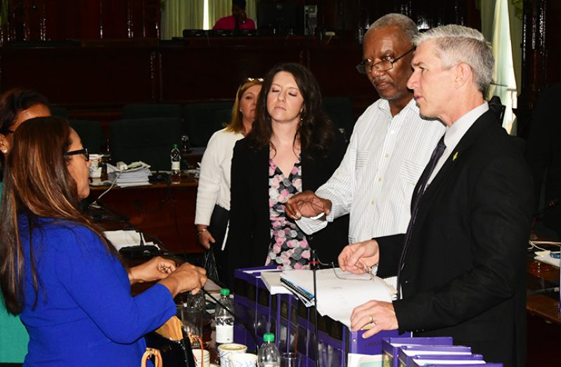 Esso Exploration’s  Rod Henson (right) interacting with Odinga Lumumba (second right), Pauline Sukhai (left) and Yvonne Pearson (partly hidden, extreme left), all members of the Parliamentary Committee on Natural Resources. Also in photo are Esso Exploration’s Senior Director for Public and Government Affairs, Deebra J.P. Moe and Socio-Economic Adviser Tracy Roberts, third and fourth right respectively (Photo by Adrian Narine)