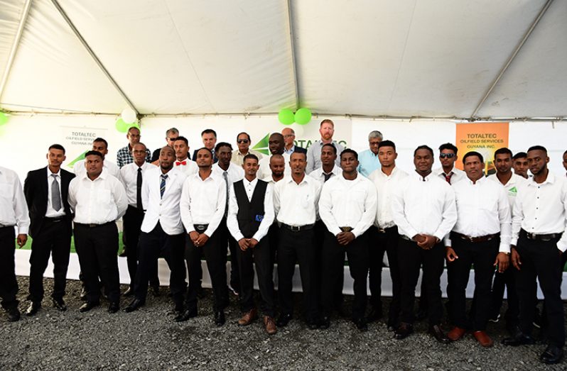 Graduates of the TotalTec academy, flanked by Prime Minister Moses Nagamootoo and stakeholders in the oil and gas academy (Samuel Maughn photos)