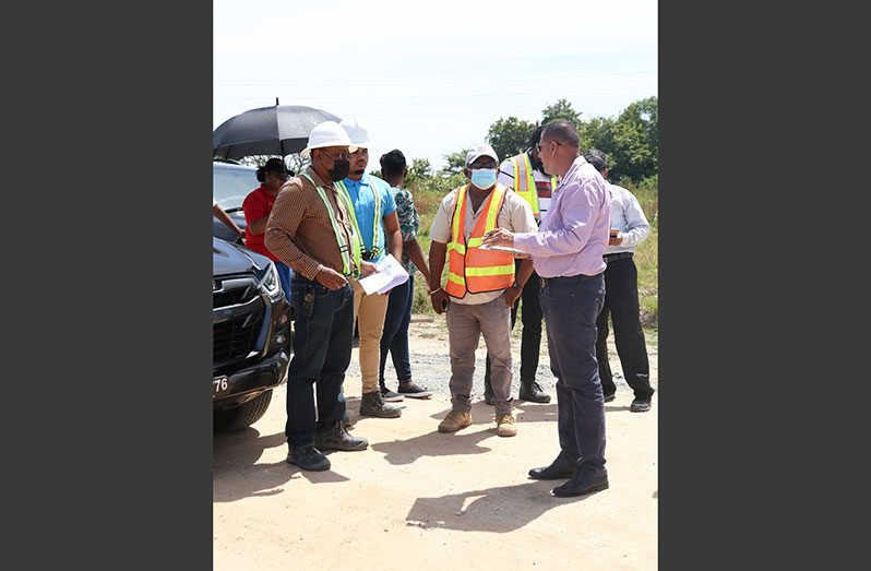 Housing and Water Minister, Collin Croal addresses engineers and contractors on site