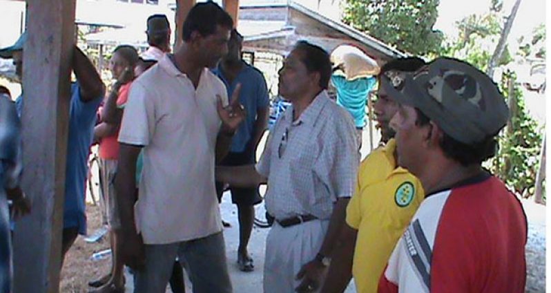 Minister Baksh having a one-on-one with farmers at the end of one of his many public meetings