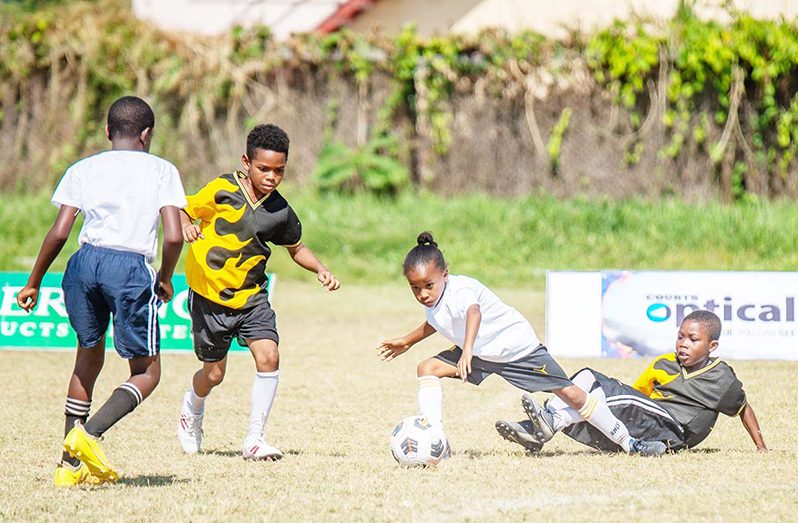 Intense play between St. Gabriel's (white) and St. Ambrose Primary (Delano Williams Photo)