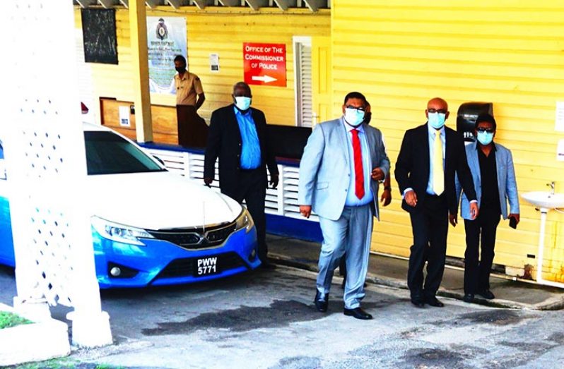 PPP/C’s General Secretary, Bharrat Jagdeo (centre); PPP/C’s Presidential Candidate, Irfaan Ali (left), and PPP/C’s Executive, Anil Nandlall, leaving Police Headquarters, Eve Leary. PPP/C’s Prime Ministerial Candidate, Mark Phillips, follows behind.