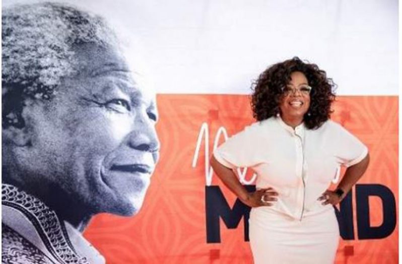 US TV personality Oprah Winfrey poses on the red carpet next to a banner depicting late former South African president Nelson Mandela, as she arrives to attend an event to mark 100 years since the birth of Nelson Mandela, at the University of Johannesburg, Soweto Campus, in Johannesburg on November 29, 2018. Oprah Winfrey will deliver a keynote address during the event. (Photo: AFP)