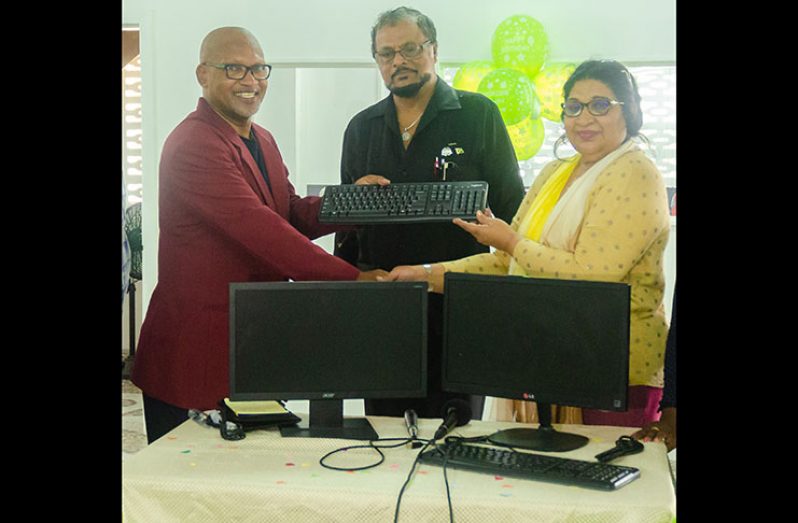 Tesouro Resources General Manager, Jaswick Williams (left), hands over the systems to CEO of the orphanage, Raheema Rahaman, as Consultant Roshan Khan, looks on (Delano Williams photo)