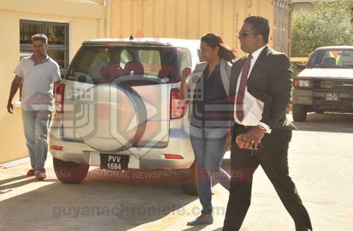 Prema Roopnarine with her lawyer, Sase Gunraj and Badrie Persaud [extreme left]