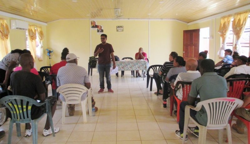 Participants listen attentively during the outreach at Port Kaituma. (Office of DPP photo)