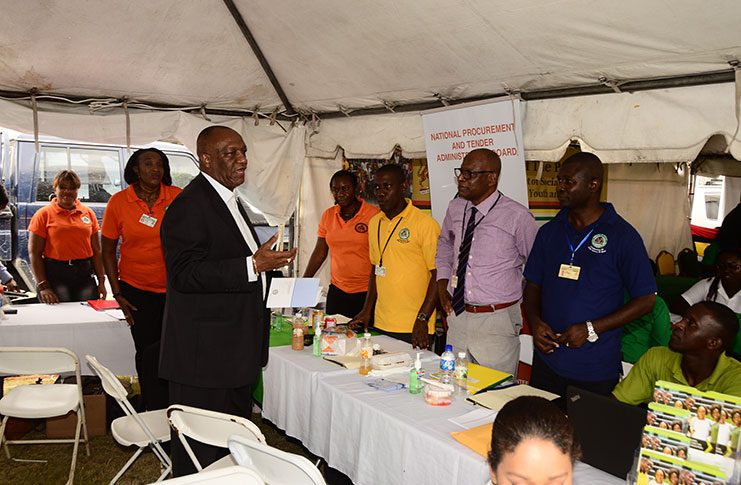 Minister of State, Joseph Harmon, speaking with officials at the National Procurement and Tender Administration Board at the Berbice Government Outreach on Tuesday