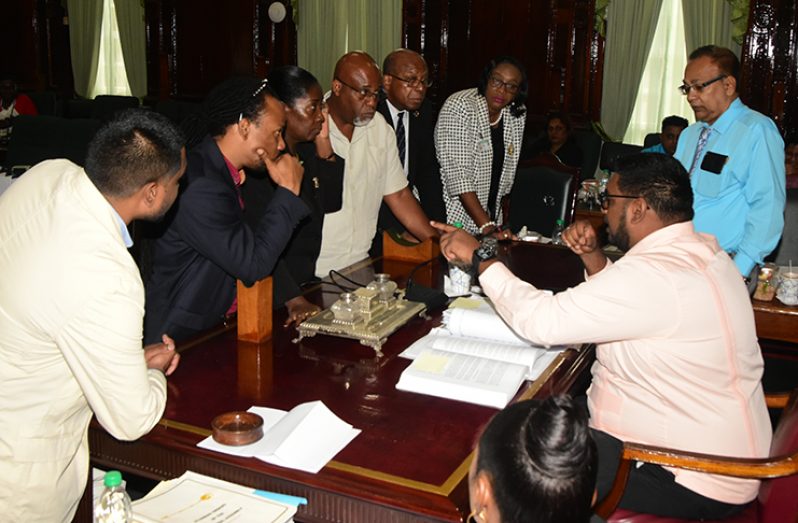 Members of PAC and its advisors consult with the Chairman of the Committee, Irfan Ali before a decision was taken on Monday. (Adrian Narine photo)