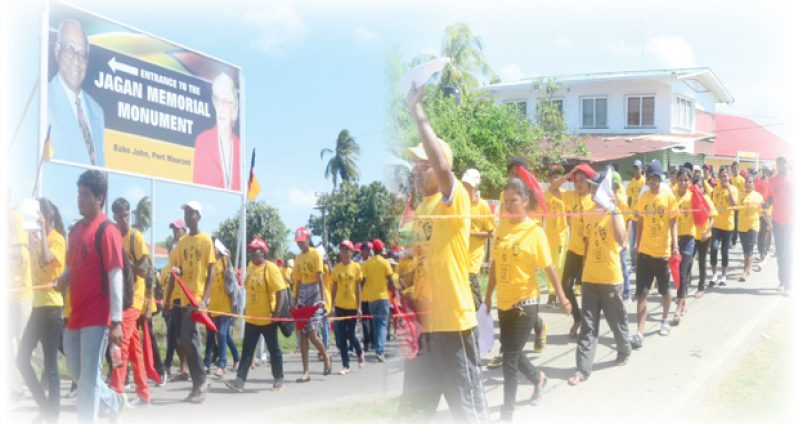 Over 300 members of the Progressive Youth Organisation (PYO) march to the Babu John Memorial site chanting, “Cheddi Jagan, Man of the People!”