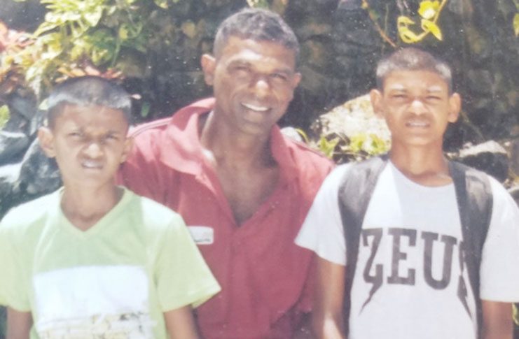 Vickram Budhram (centre) pictured with his two sons