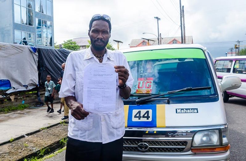 United Minibus Union (UMU) President Eon Andrews holds up a copy of the Memorandum which stipulates the areas designated to minibuses in Georgetown and the routes they are to take.