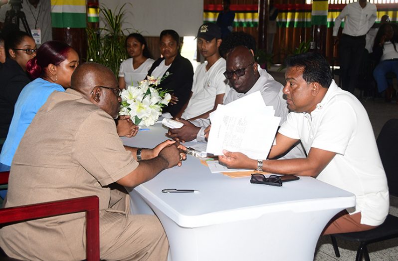 Attorney and executive member of the Federal United Party (FED-UP), Chandra Sohan (right) as he submitted his party’s list to GECOM’s Chief Elections Officer, Keith Lowenfield (Adrian Narine photos)