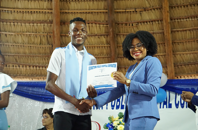 Orwin Corlette receiving his certificate at the graduation ceremony
