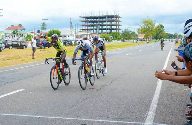 Alonzo Greaves (right) narrowly pips Team Coco’s Hamza Eastman (left) across the finish line to win yesterday’s third stage of the NSC sponsored three-stage cycle road race.