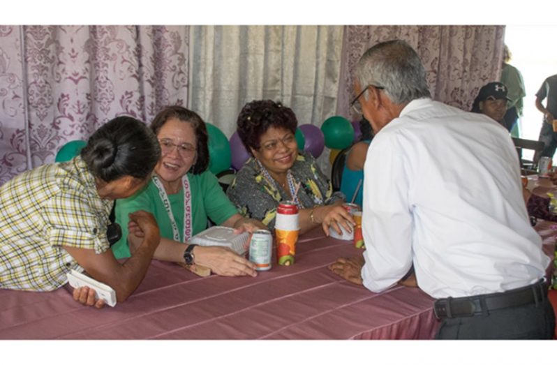 Senior residents of Paramakatoi interacting with First Lady, Her Excellency, Sandra Granger and Minister of Social Protection, Hon. Amna Ally.