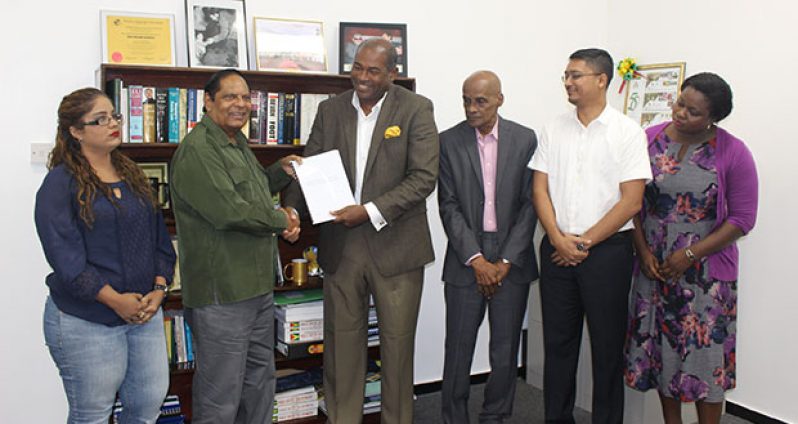 Prime Minister Moses Nagamootoo receiving the Constitutional Reform Report from the CRSC in the presence of other members of the committee on Saturday at his office