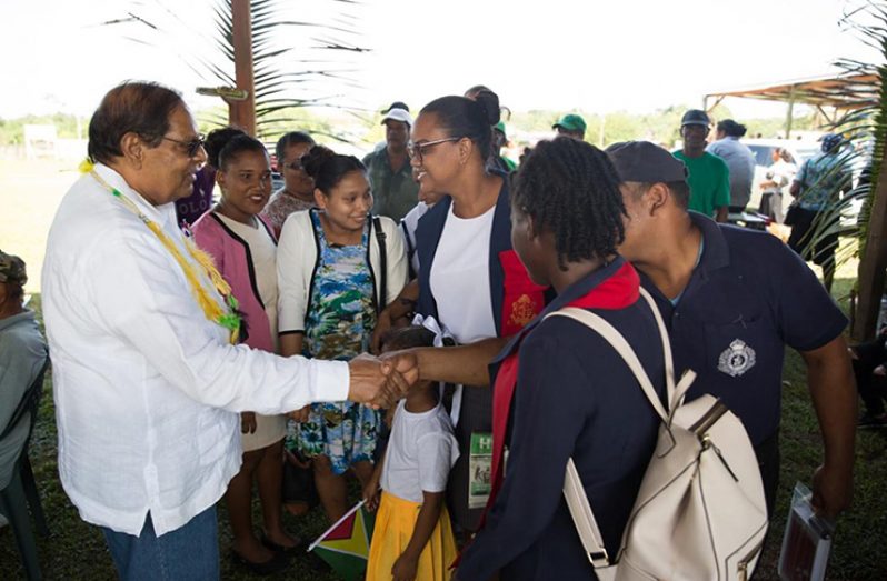 Prime Minister Moses Nagamootoo greeting teachers and other residents during his recent visit to Port Kaituma