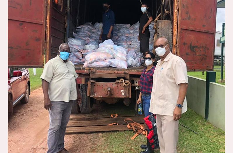 Prime Minister Brigadier (ret’d) Mark Phillips; Public Service Minister, Sonia Parag and Public Works Minister Juan Edghill distributing a quantity of food and sanitary supplies to the flood-affected residents of Region 10
