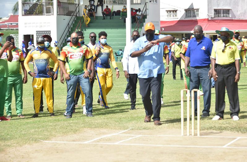 Set to deliver! Prime Minister Brigadier (Ret'd) Mark Phillips gets ready to deliver a ball during yesterday’s opening of the Prime Minister T20 Softball Cup.