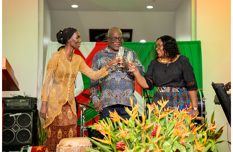 Suriname’s Ambassador to Guyana, Her Excellency, Liselle Blankendal shares a Golden Jubilee toast with Prime Minister, Brigadier (Ret'd), the Honourable Mark Phillips and his wife, Mrs Mignon Bowen-Phillips