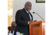 Prime Minister Brigadier (Ret'd) Mark Phillips delivering a speech at the funeral service