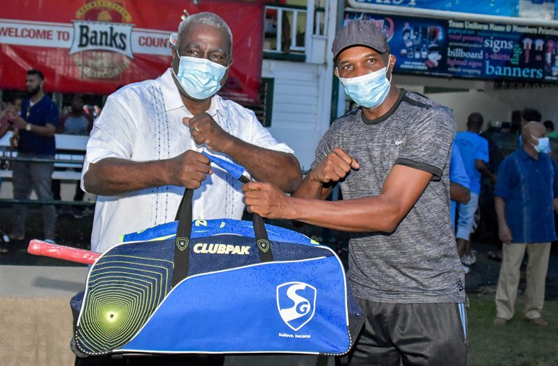 Prime Minister Brigadier (ret’d) Mark Phillips (left) during the recent donation to Transport Sports Club’s Shaun Massiah.