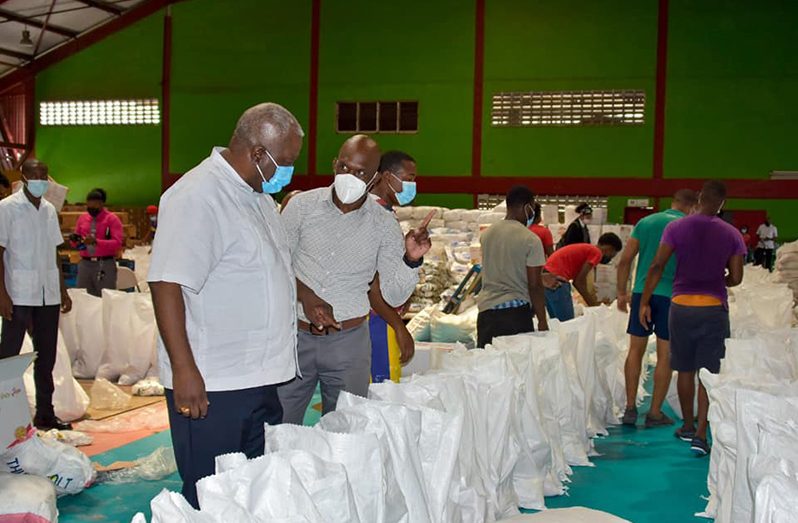 Prime Minister, Brigadier (Ret’d) Mark Phillips, overlooking the packing of flood-relief items