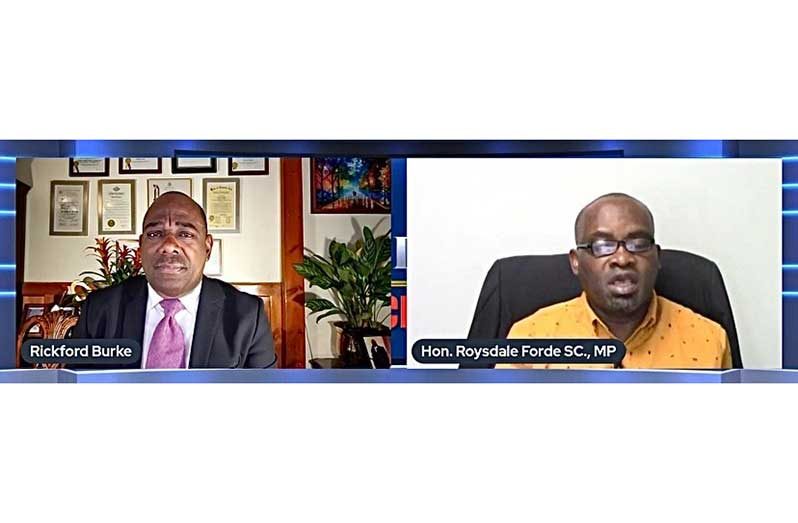 Rickford Burke (left) and PNCR Executive Member, Roysdale Forde (right)