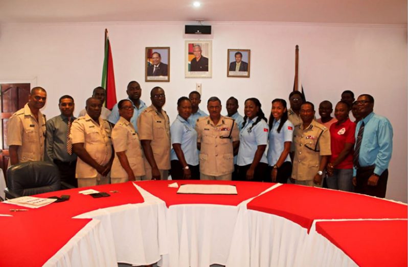The Trinidadians (in light blue), along with GPF Commissioner (ag) David Ramnarine (centre) and other officials.
