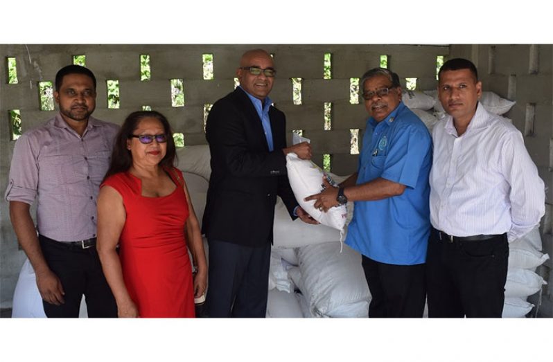 Opposition Leader Bharrat Jagdeo (third left) presents a bag of rice to Director-General of the CDC, Colonel (Rtd) Chabilall Ramsarup (second right). Also in the photo are (left) Nigel Dharamlall, Pauline Sukhai and (extreme right), Collin Croal
