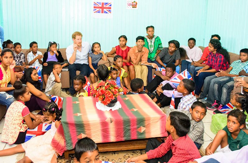 Prince Harry interacting with residents of the Joshua House Children Centre when he visited the orphanage
on Sunday (Samuel Maughn photo