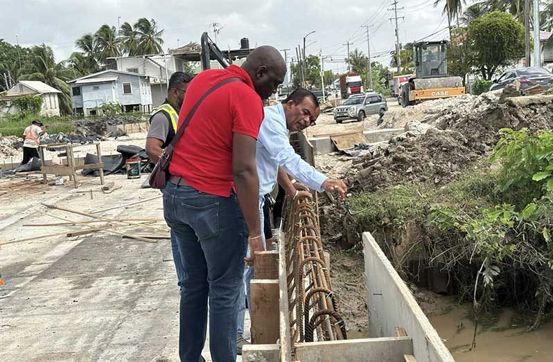 Minister within the Ministry of Public Works, Madanlall Ramraj, examines ongoing structural works alongside engineers and contractors during the inspection on Saturday