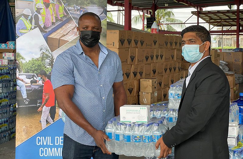 Leader of the East Coast Demerara Progressive Youth Organisation, and the Assistant Director of Youth at the Ministry of Culture Youth and Sport, Suresh Singh making the contribution on behalf of his group to Deputy Director-General of the Civil Defence Commission, Major Loring Benons at the Muslim Youth Organisation on Woolford Avenue, Georgetown on Monday
