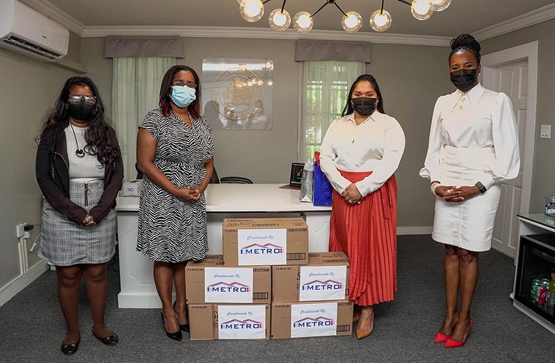 First Lady, Arya Ali (second from right) receives a donation from Metro