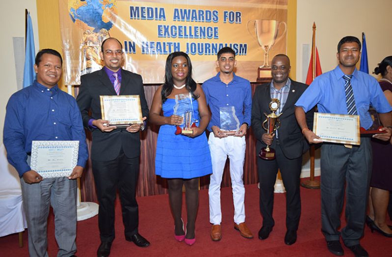 Chronicle reporters (from left to right) Alva Solomon, Rabindra Rooplall, Svetlana Marshall and Ravin Singh with Editor-in-Chief Nigel Williams (2nd from right) and News Editor Tajeram Mohabir at last evening’s award ceremony (Photo by Cullen Bess-Nelson)