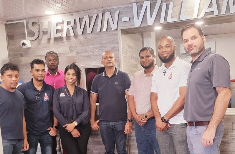 Sales Director for the Caribbean, Rafael Arango (first, right); Vincent Thakur, Manager Director for AMSI (fourth from right); Lancelot Gordon, Business Development Manager at AMSI (second from right); Paint Technician, Totaram Bishundat (third from right), and other AMSI staff