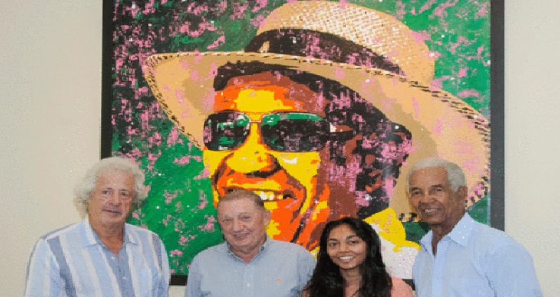 PICTURE PERFECT: Sir Garry Sobers (right) posing at the unveiling of his new painting next to the artist Jeena Chatrani (second right), Sandy Lane owner Derrick Smith (second left) and the man who initially had the winning bid for the piece, Sir Martyn Arbib. (Picture by Brooks LaTouche)