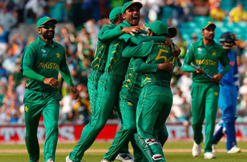 Pakistan players celebrate their victory over India on the pitch after the ICC Champions Trophy final cricket match between them at The Oval in London on Sunday.